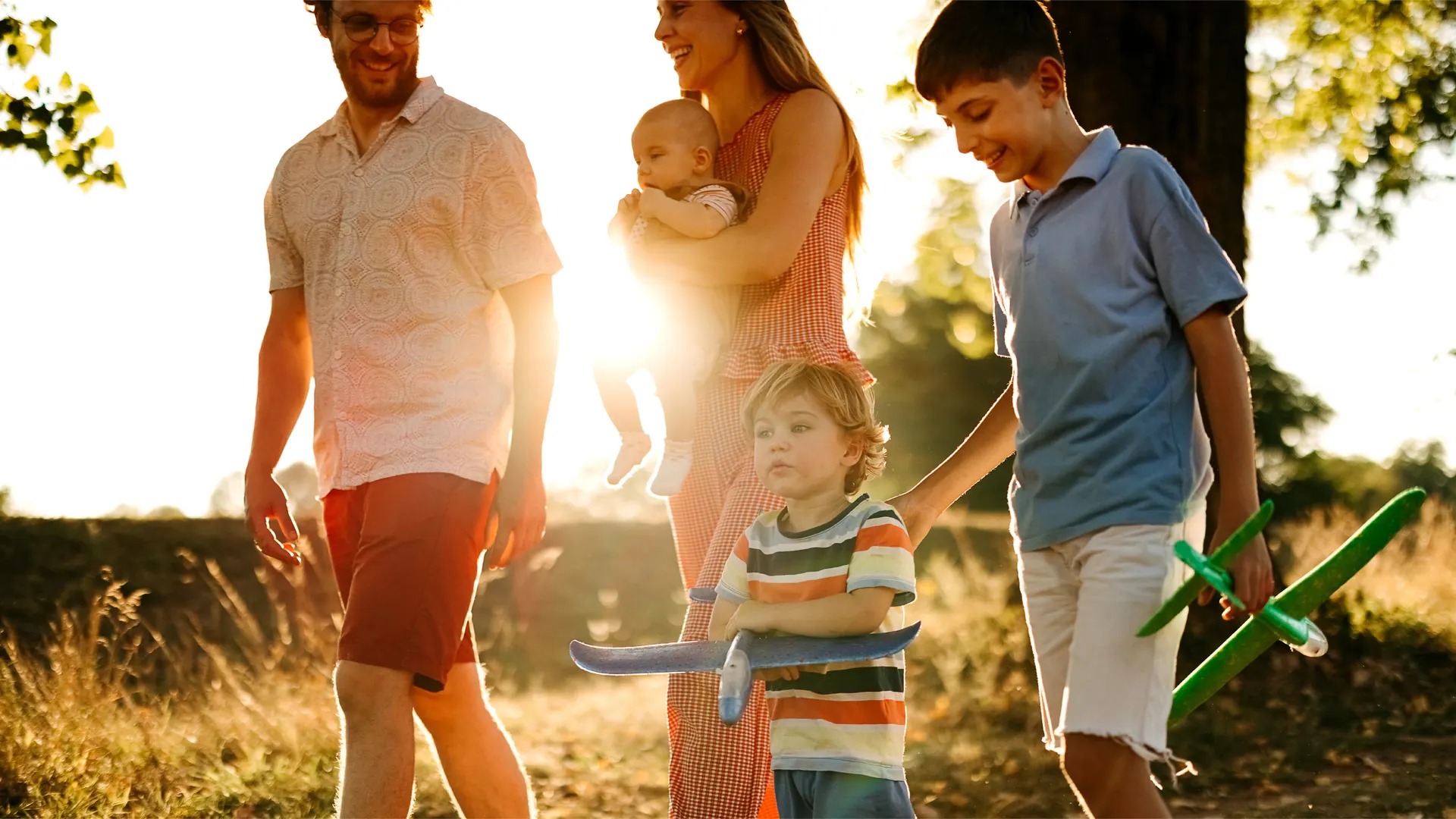 Lifestyle photograph used in Bolton Place marketing — a family walking at golden hour near Bolton, Caledon. Not an architectural rendering of the community.